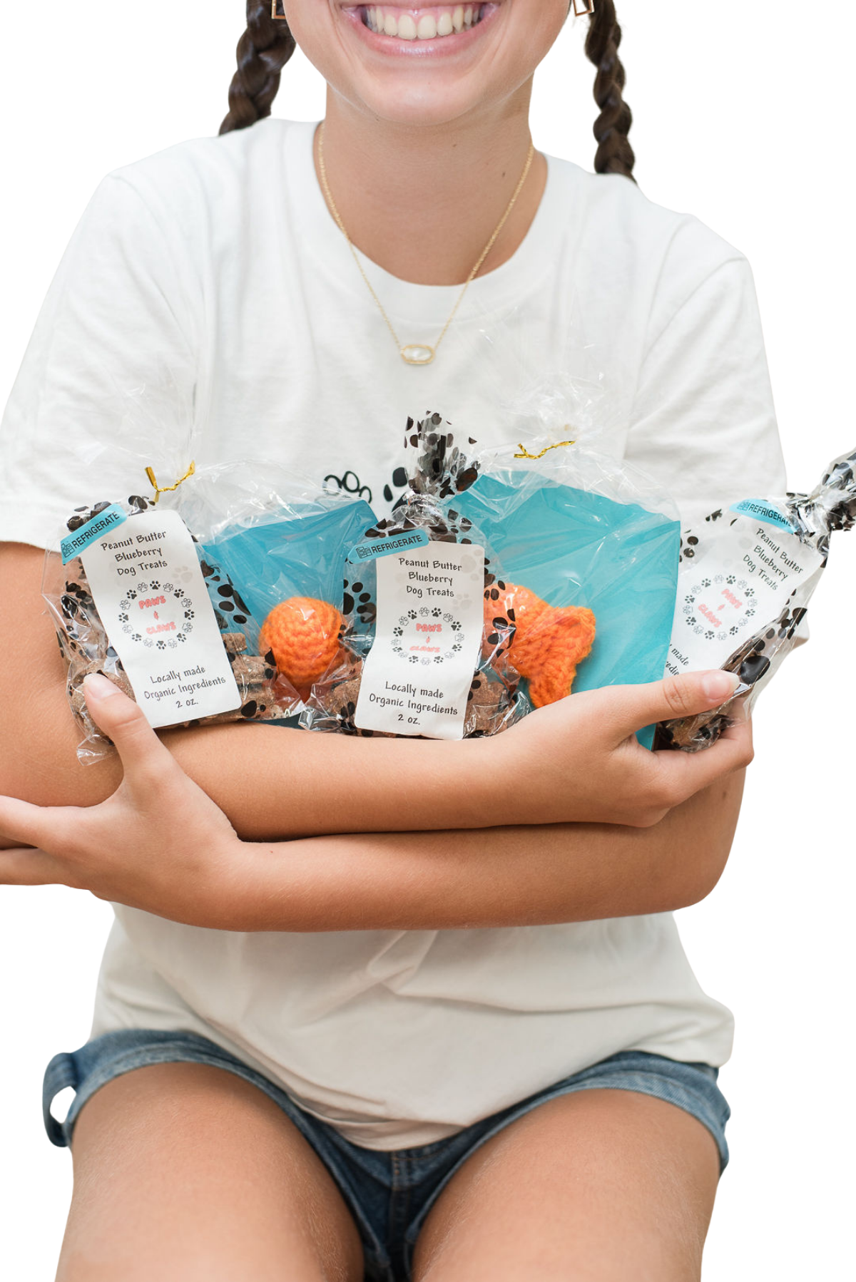Young entrepreneurs with their handmade products and Little Brands Collective sign