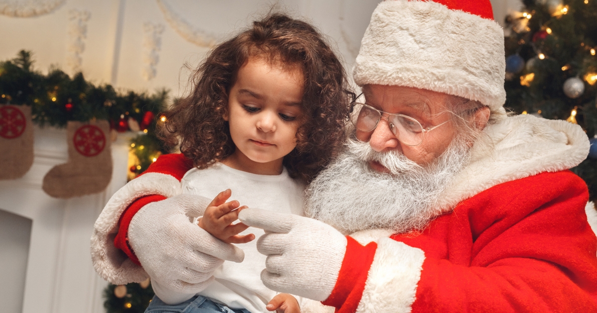 Santa sharing a quiet moment with two children on his lap